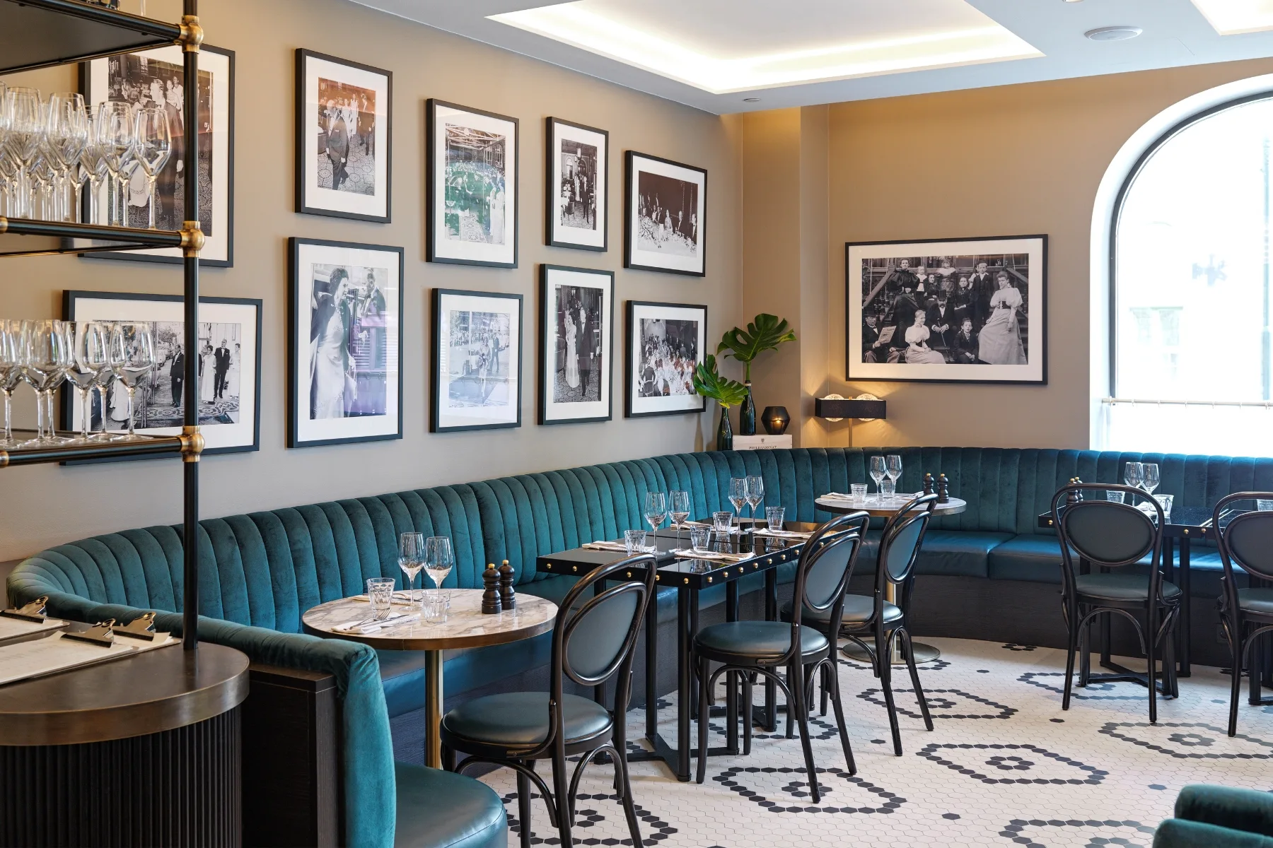 the restaurant interior features contract furniture with blue couches and framed pictures - contract furniture